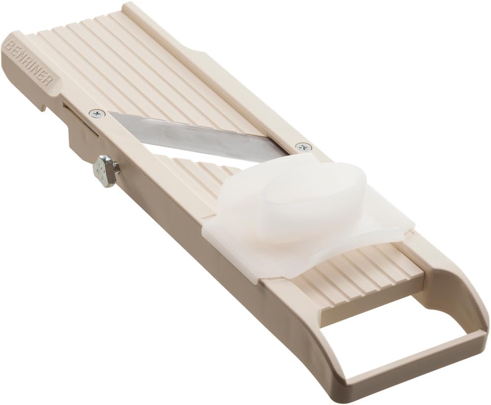 Beige four-blade Benriner mandoline slicer with the BENRINER name molded into the frame, a stainless blade and a white finger guard