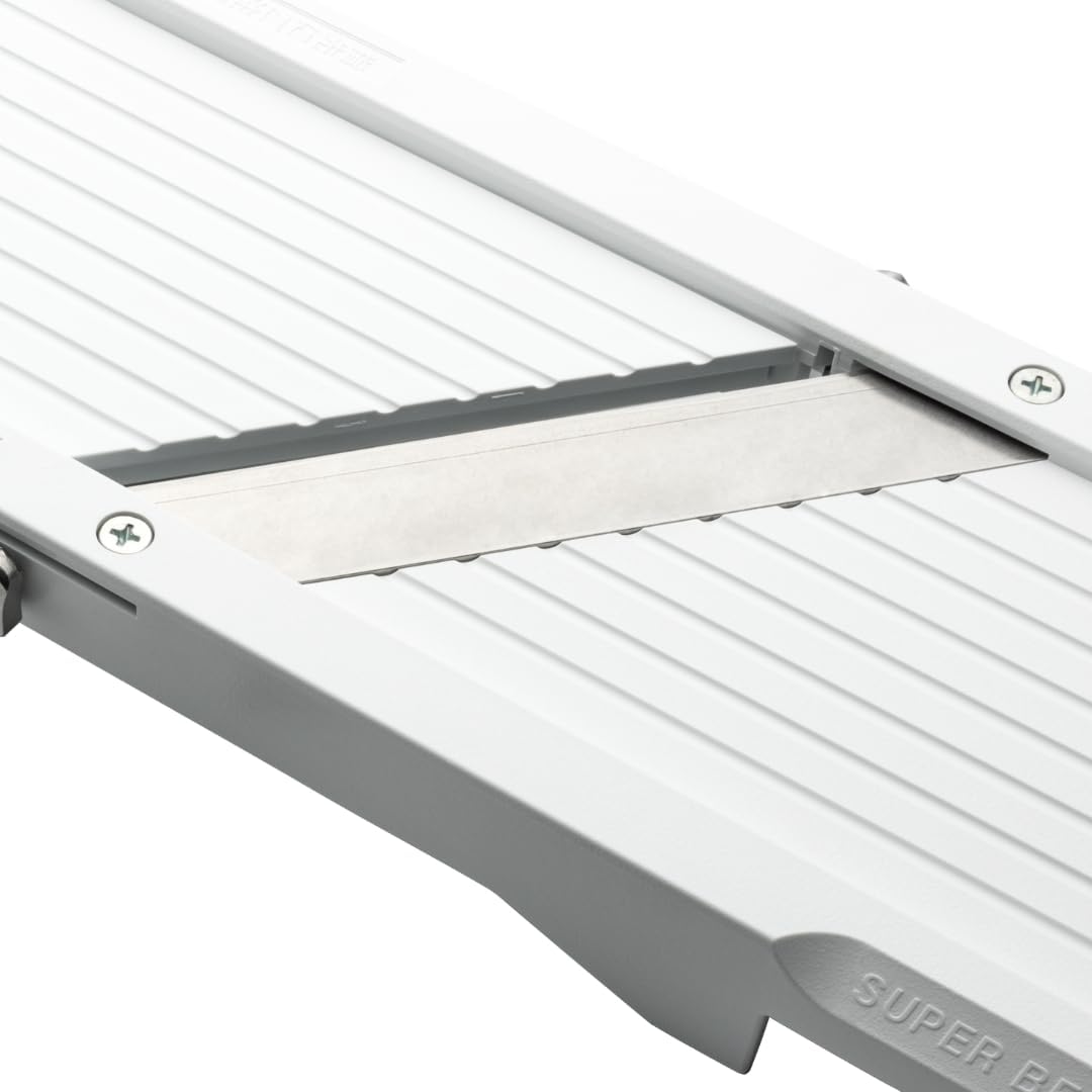 Close view of a genuine Benriner replacement flat blade seated in the white body of a Super Benriner