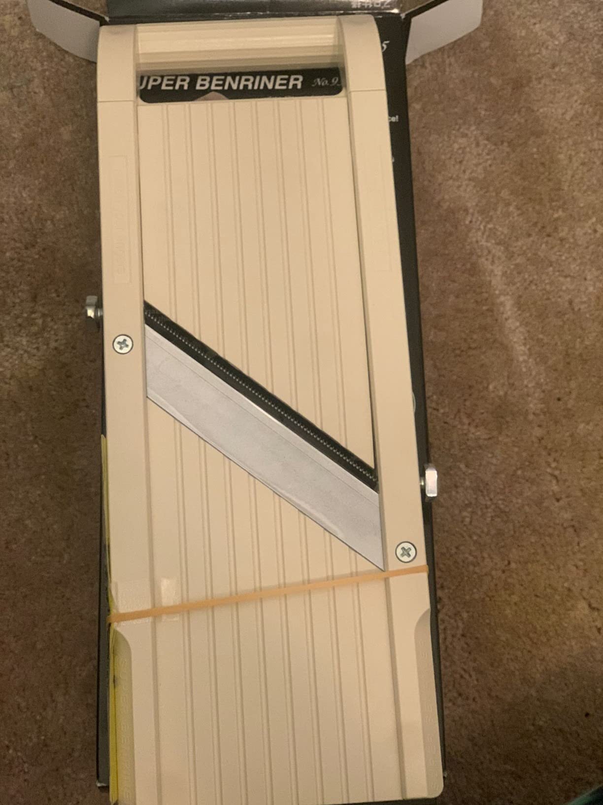 Beige Super Benriner No. 95 still banded into its box, with the diagonal stainless blade and both thickness screws visible