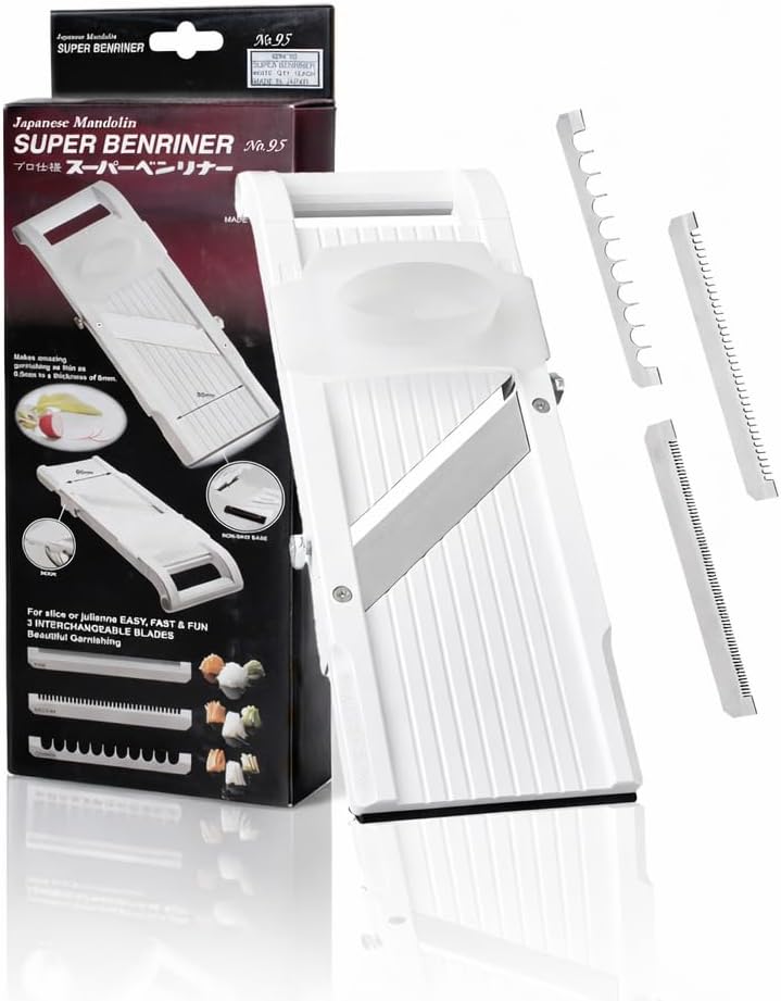 White Super Benriner No. 95 mandoline standing beside its retail box with the three interchangeable comb blades laid out alongside